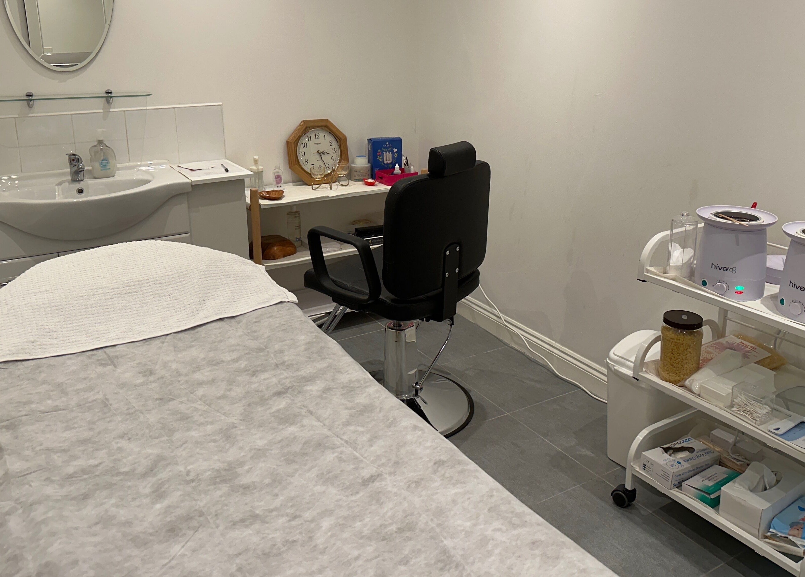 Cozy treatment room at Totally Tips and Toes, London, England, GB, featuring a massage table and waxing station.