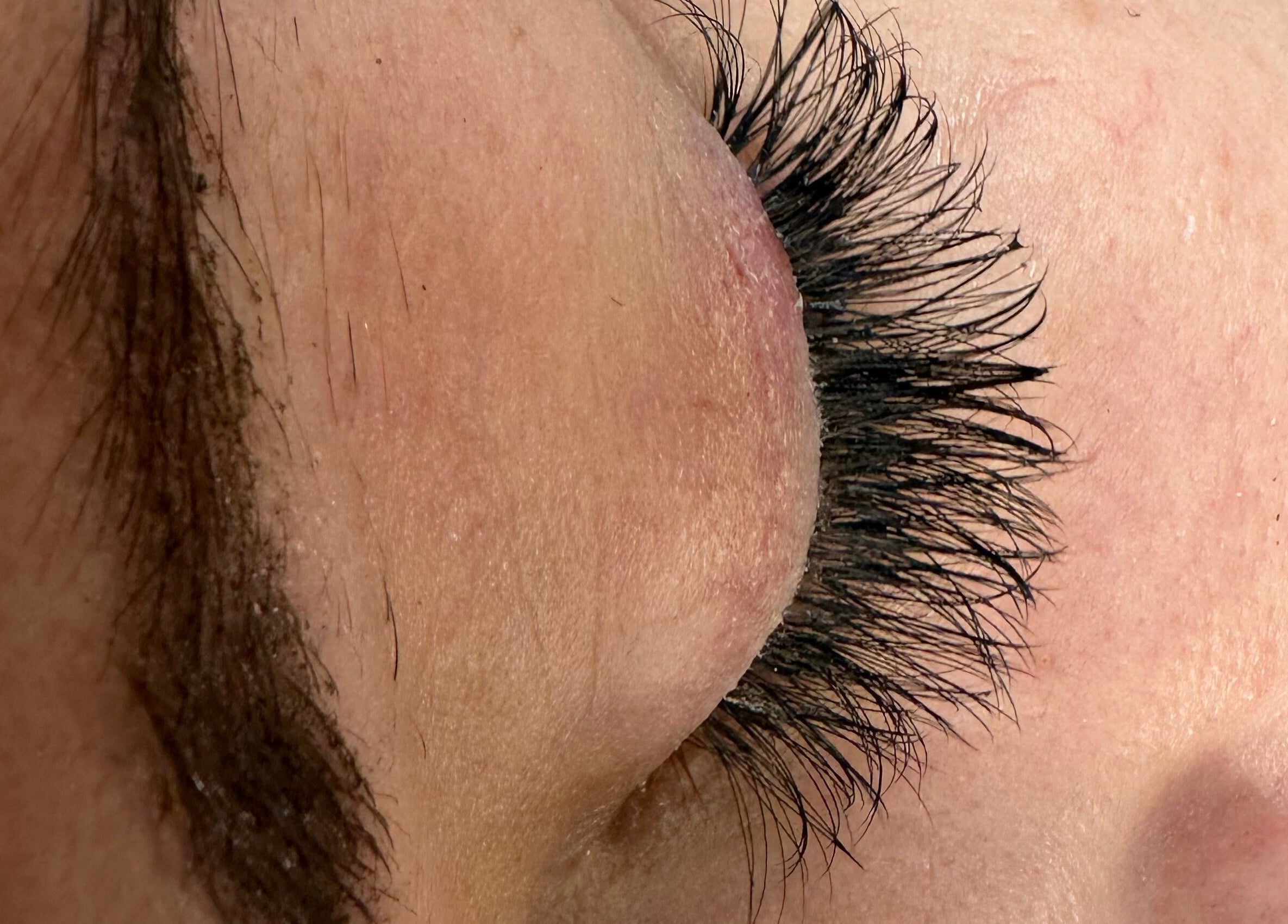 Closeup of enhanced eyelashes at Totally Tips and Toes in London, England, GB.