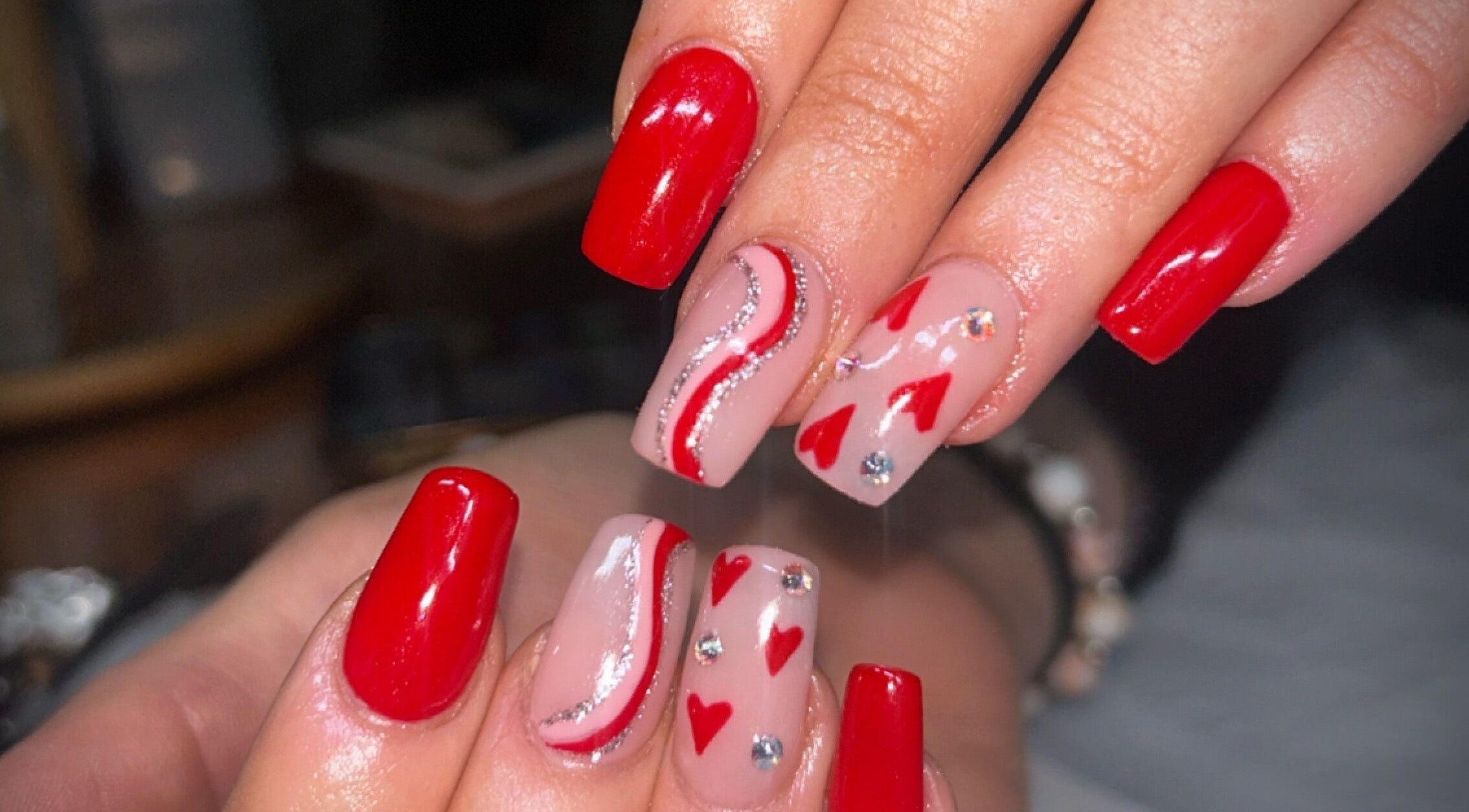 Red and pink nail art at Beauty by Paige in Stoke-on-Trent, England, GB showcases intricate design.