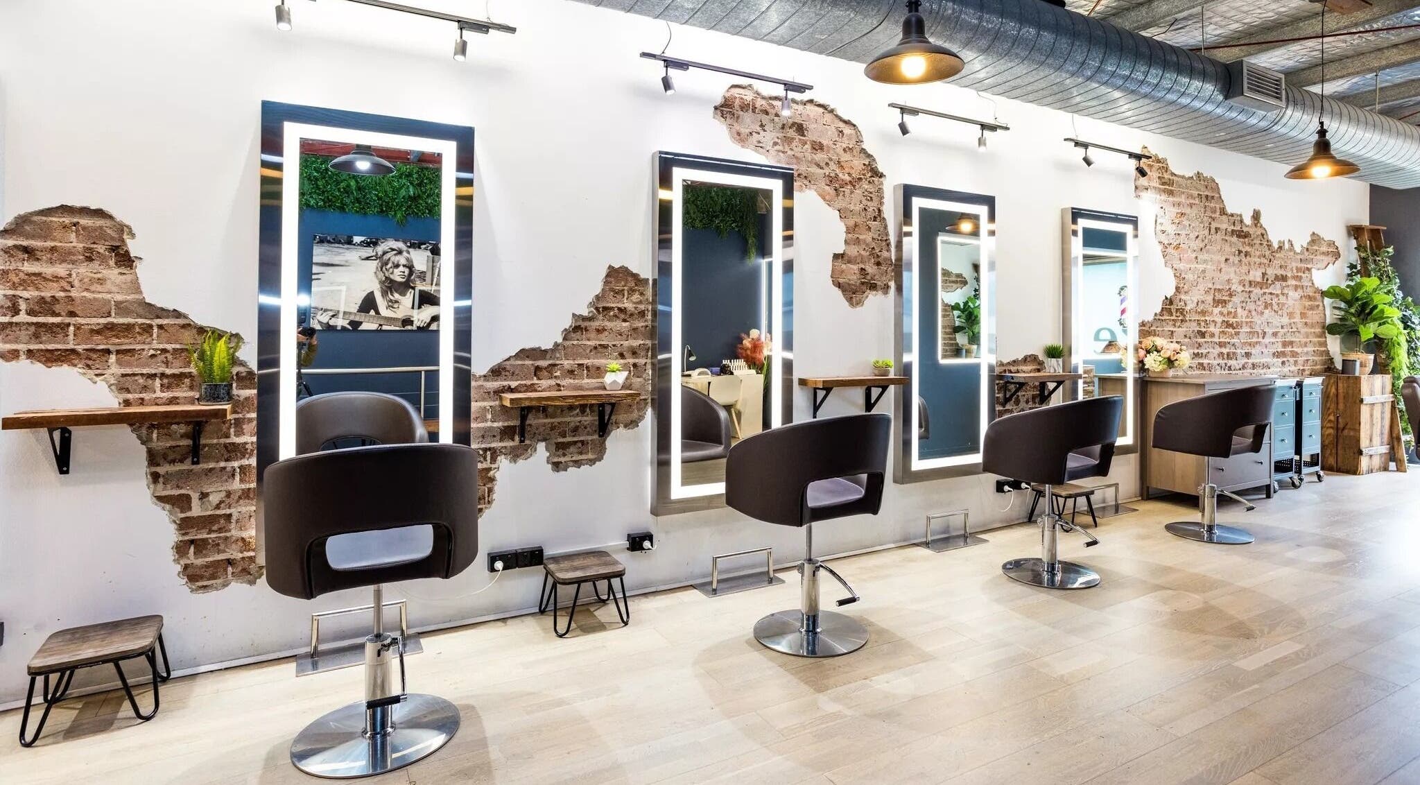 Evoke Hair Salon Rosebery in Rosebery, New South Wales, AU features stylish industrial decor with exposed brick walls.
