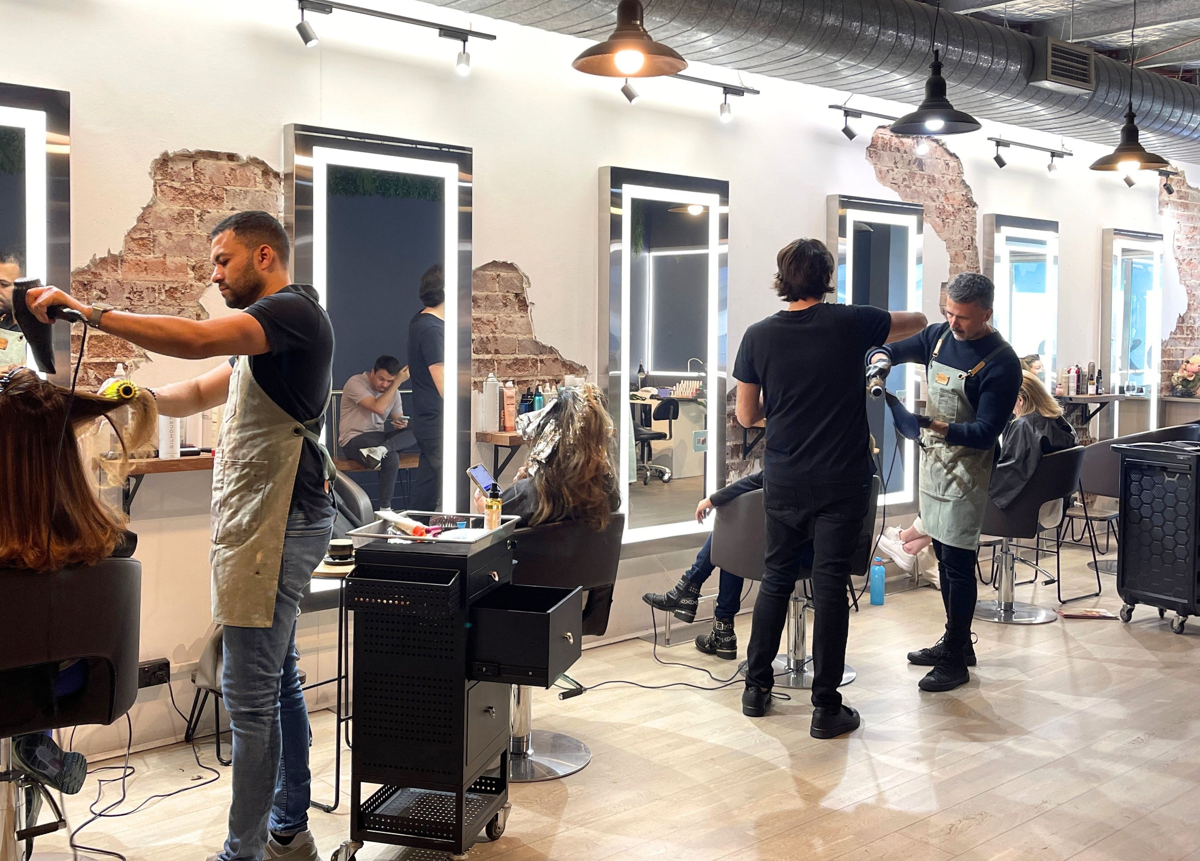 Stylists at work in Evoke Hair Salon Rosebery, vibrant ambiance, Rosebery, New South Wales, AU.