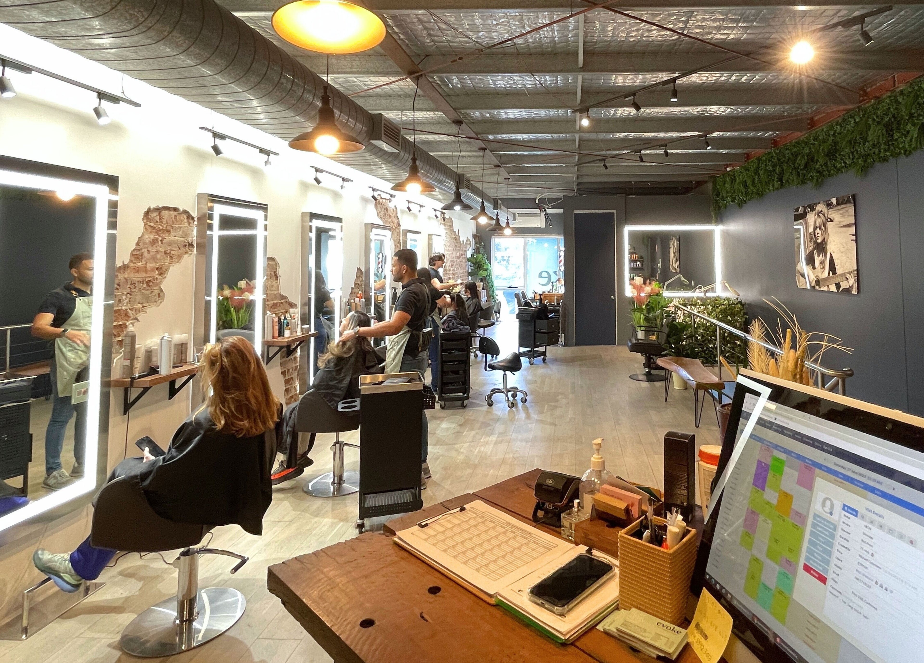 Modern interior of Evoke Hair Salon Rosebery in Rosebery, New South Wales, AU with customers and stylists.