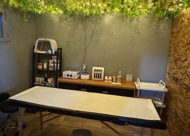 Tranquil spa room at Shiren Hair & Beauty, Regina, SK, CA with treatment bed and soothing greenery.