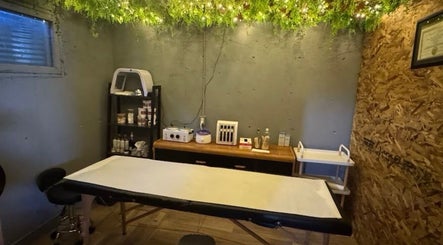 Tranquil spa room at Shiren Hair & Beauty, Regina, SK, CA with treatment bed and soothing greenery.