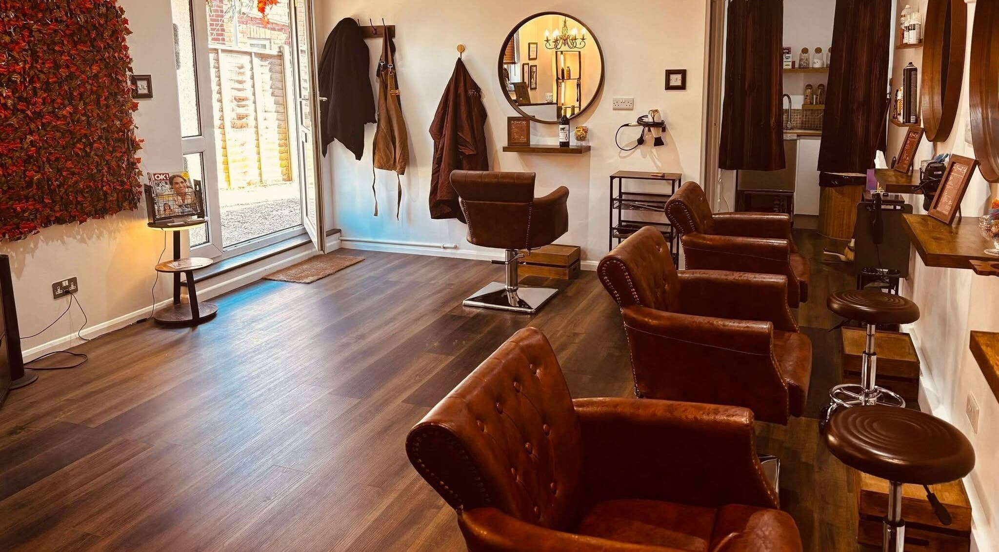 The Barnet Lodge salon interior in Portsmouth, England, GB featuring vintage leather chairs and modern decor.