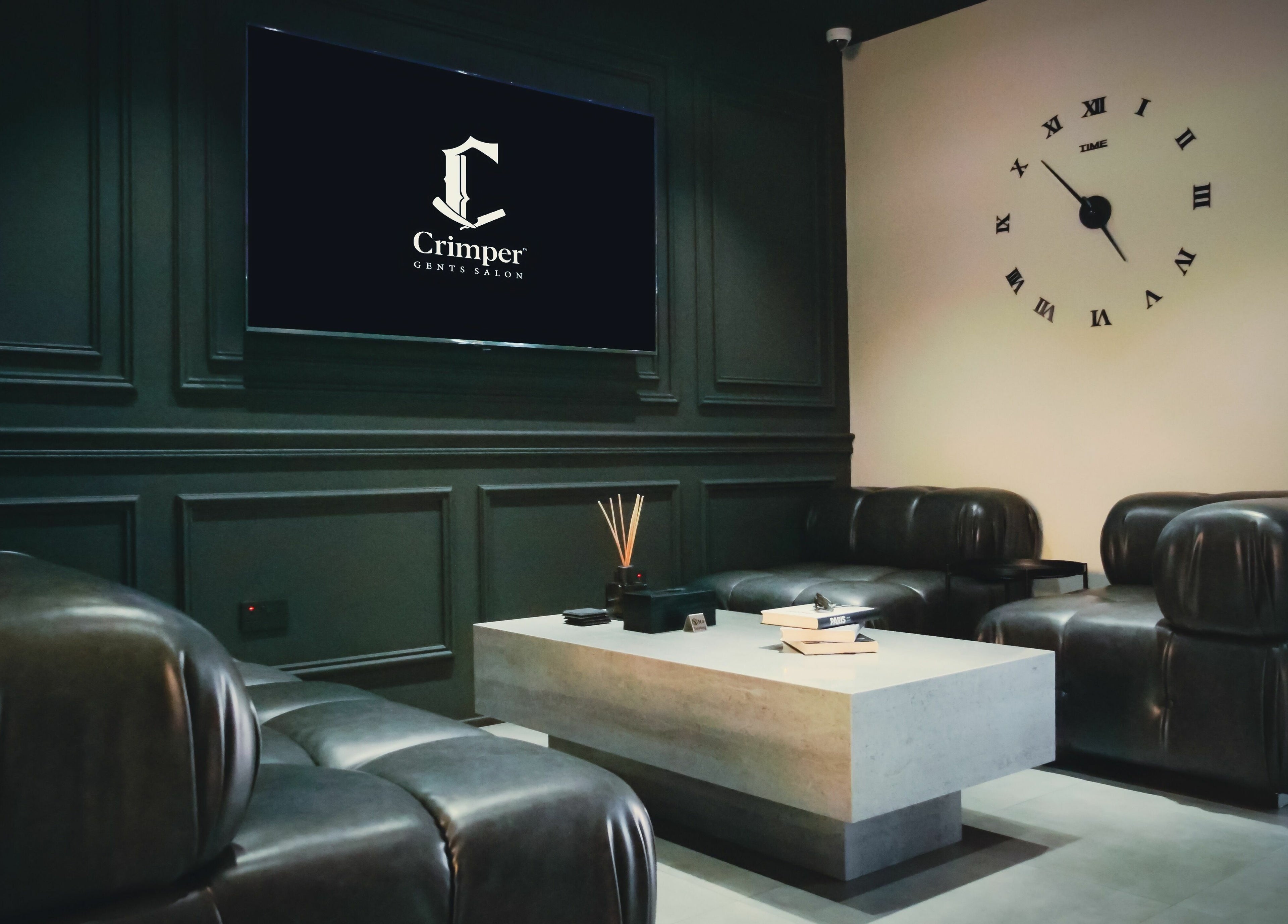 Sophisticated lounge at Crimper Gents Salon and Spa, Dubai, AE, featuring plush seating and sleek decor.
