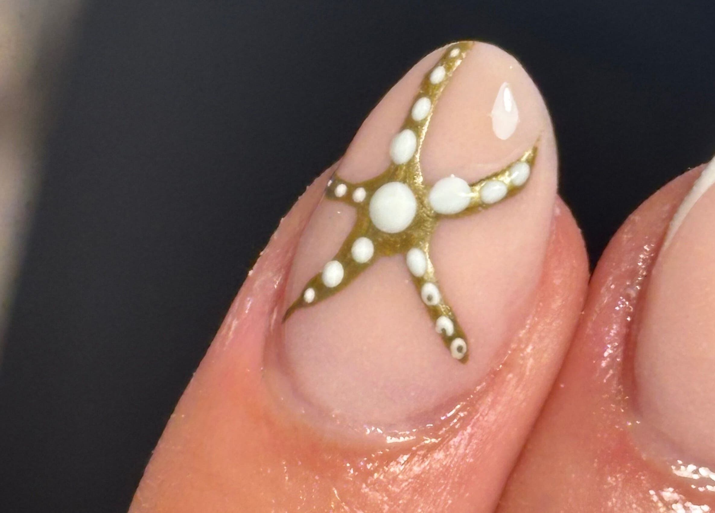 Gold and white starfish nail art by Nail Babe By Sophie in Nottingham, England, GB.
