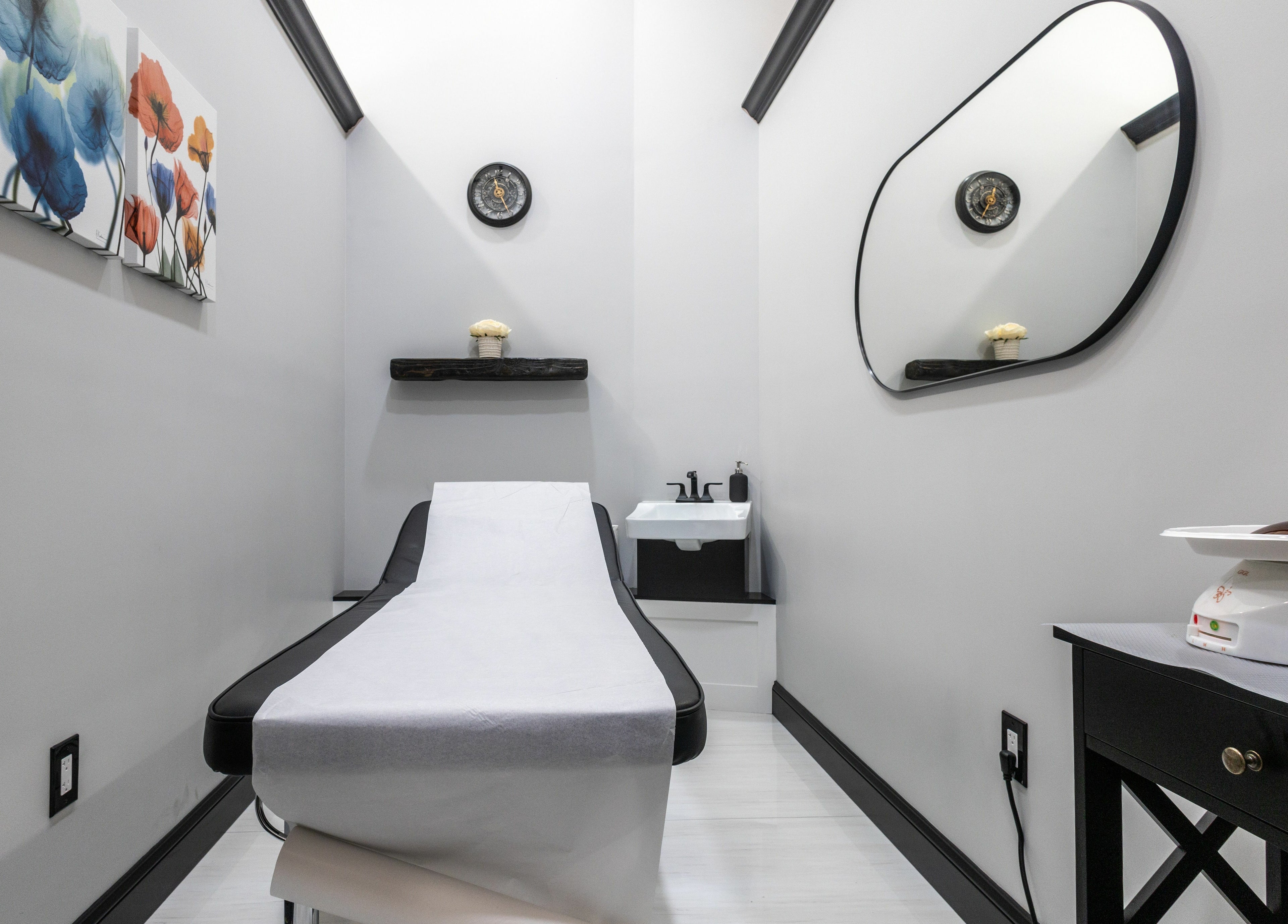 Relaxing treatment room at Top Nails Spa II in Closter, New Jersey, US, featuring modern decor and a massage bed.