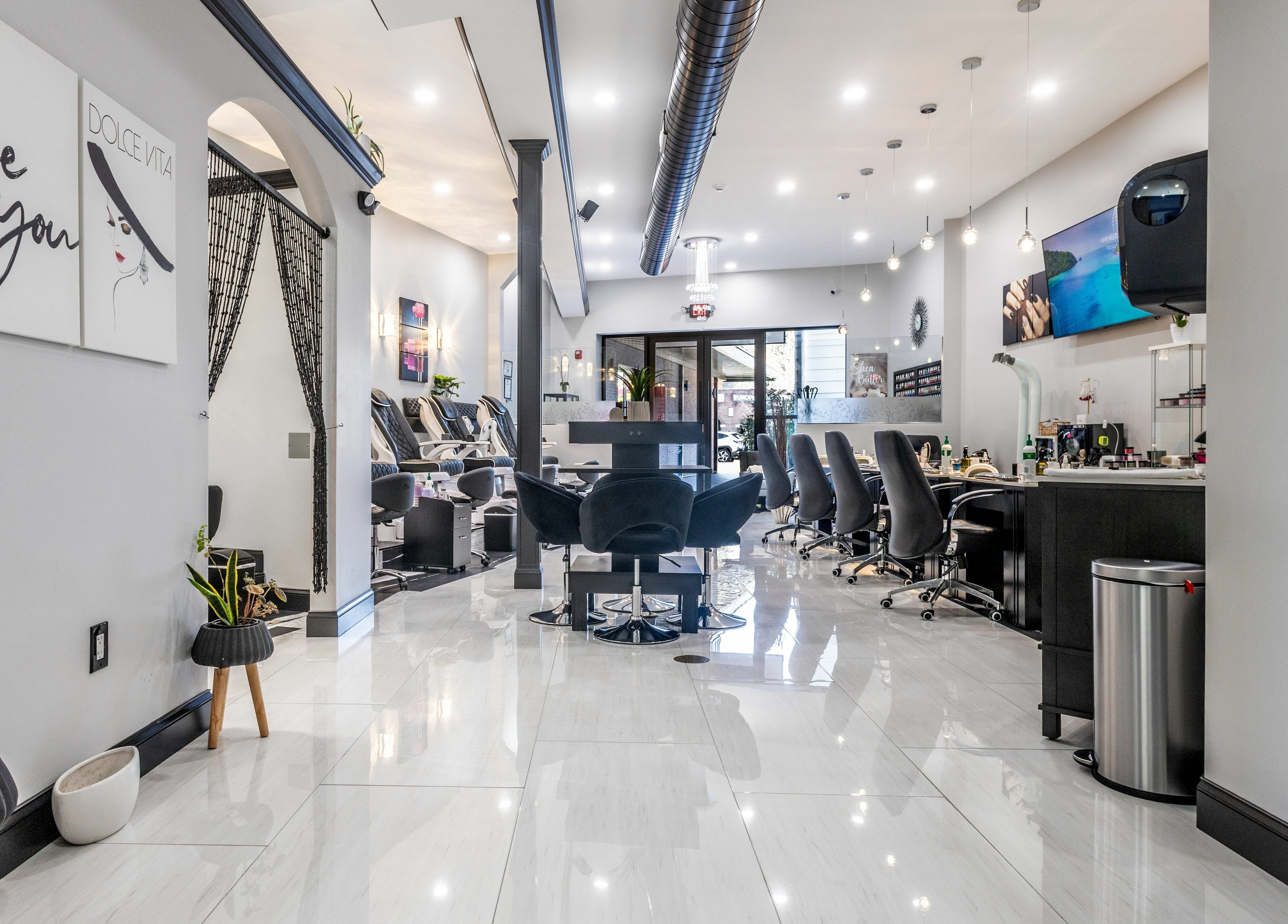 Modern interior of Top Nails Spa ll in Closter, New Jersey, US showcasing chic nail stations and elegant decor.