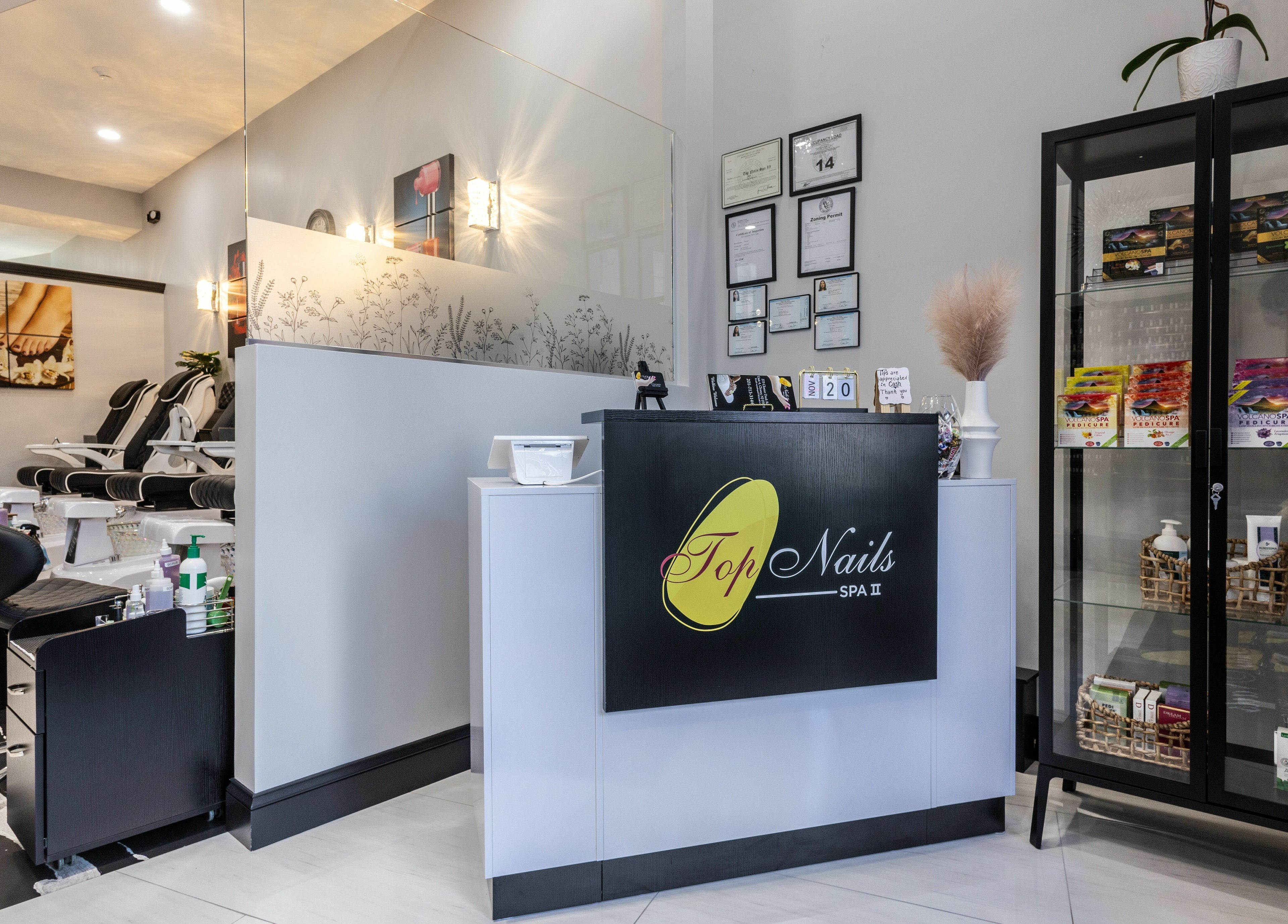 Reception at Top Nails Spa II in Closter, New Jersey, US, featuring manicure stations and product display.