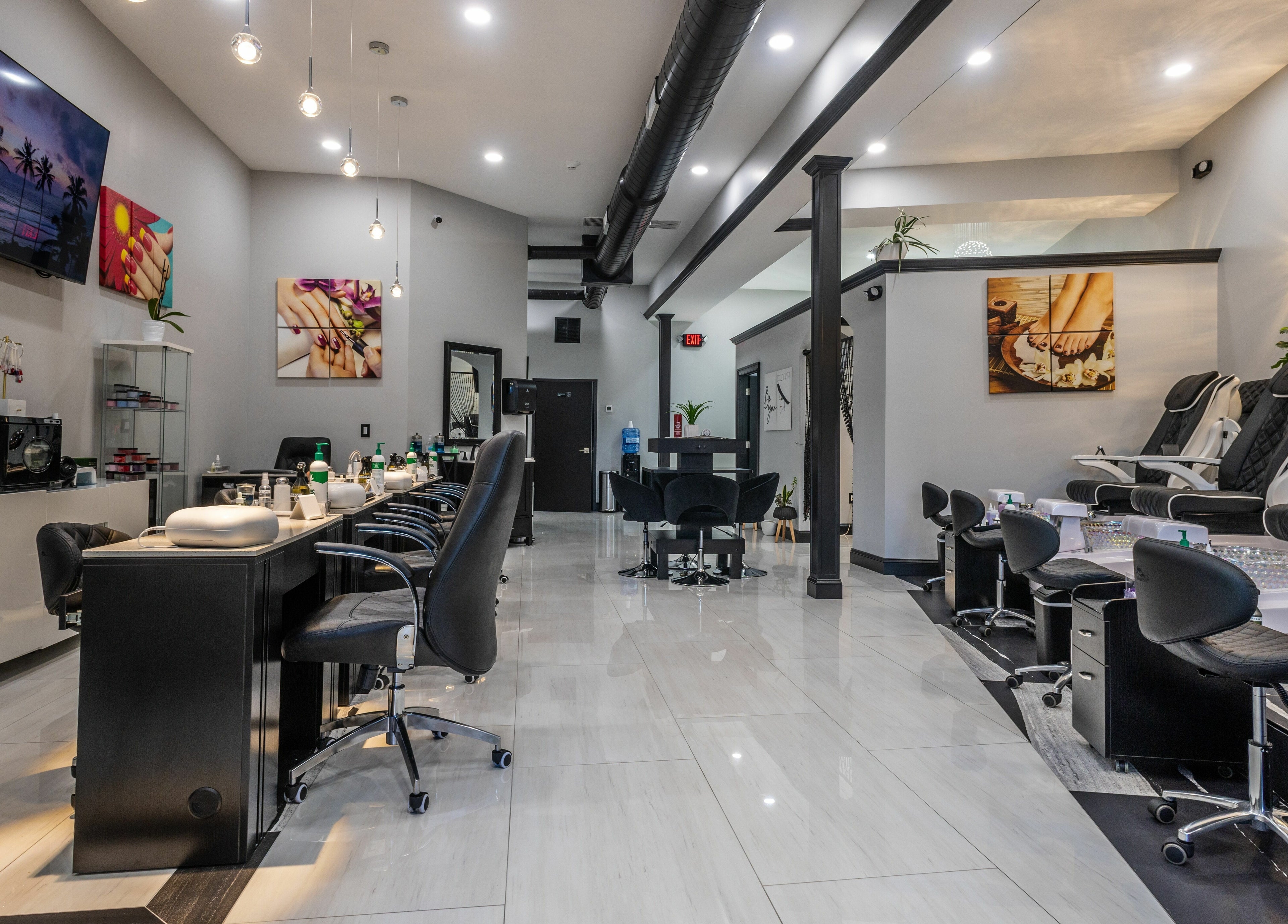 Elegant interior of Top Nails Spa ll in Closter, New Jersey, US with modern nail stations and plush chairs.