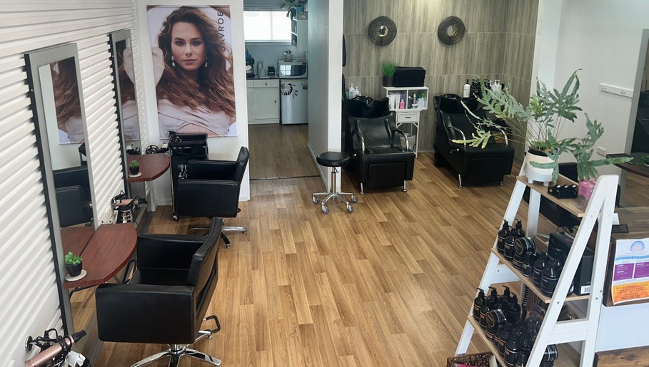 Modern interior of Kut Loose Hairdesign Robe, featuring styling stations and products in Robe, South Australia, AU.