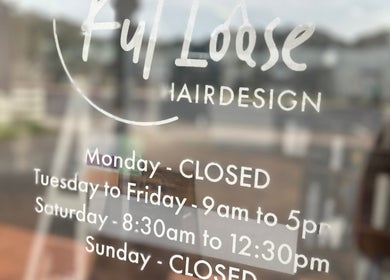 Kut Loose Hairdesign Robe hours on glass door, Robe, South Australia, AU.