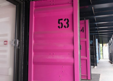 Bright pink doors at Paul Sri in London, England, GB, showcasing modern and vibrant design.
