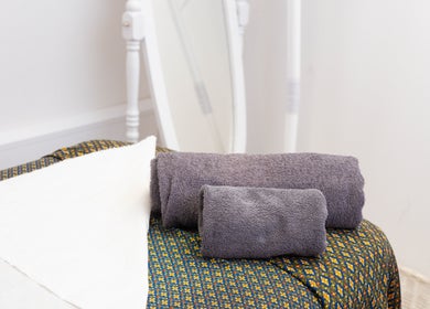 Cozy massage table setup at Paul Sri, London, England, GB with plush towels and elegant decor.