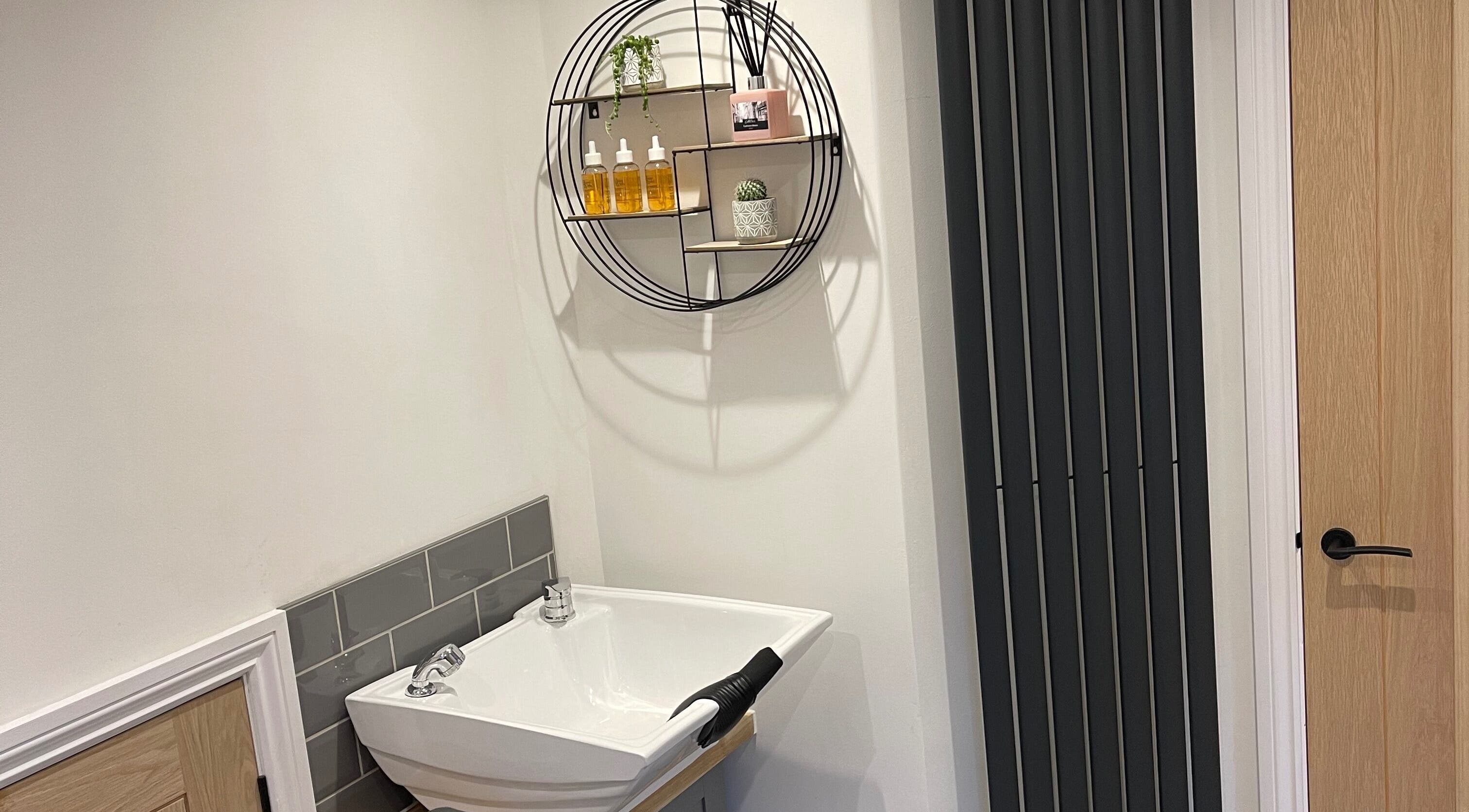 Modern salon sink with circular shelf at Natalie Mae Hair, Sturminster Newton, England, GB.
