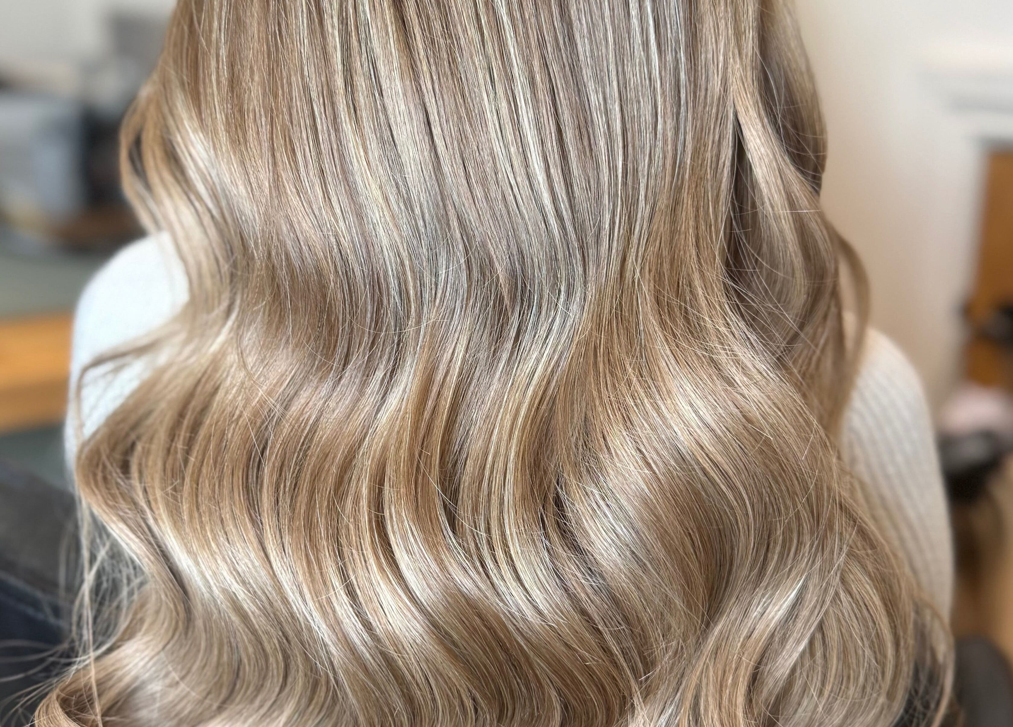 Elegant wavy blonde hair styled at Natalie Mae Hair, Sturminster Newton, England, GB.
