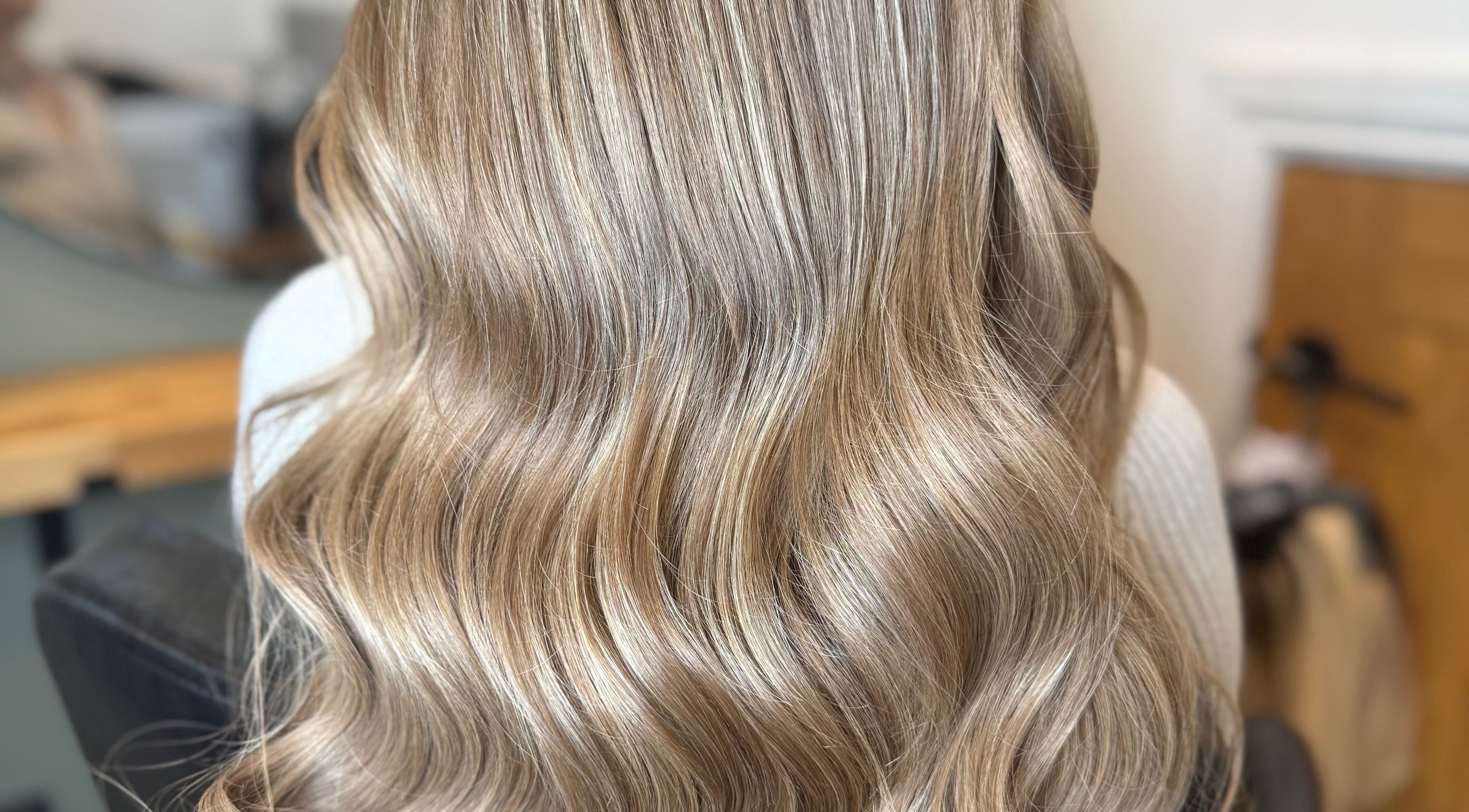 Elegant wavy blonde hair styled at Natalie Mae Hair, Sturminster Newton, England, GB.