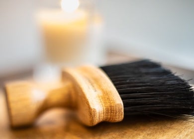 A professional styling brush at Miles Rhodes Hair Stylist in Bath, England, GB, with a soft candlelit aura.