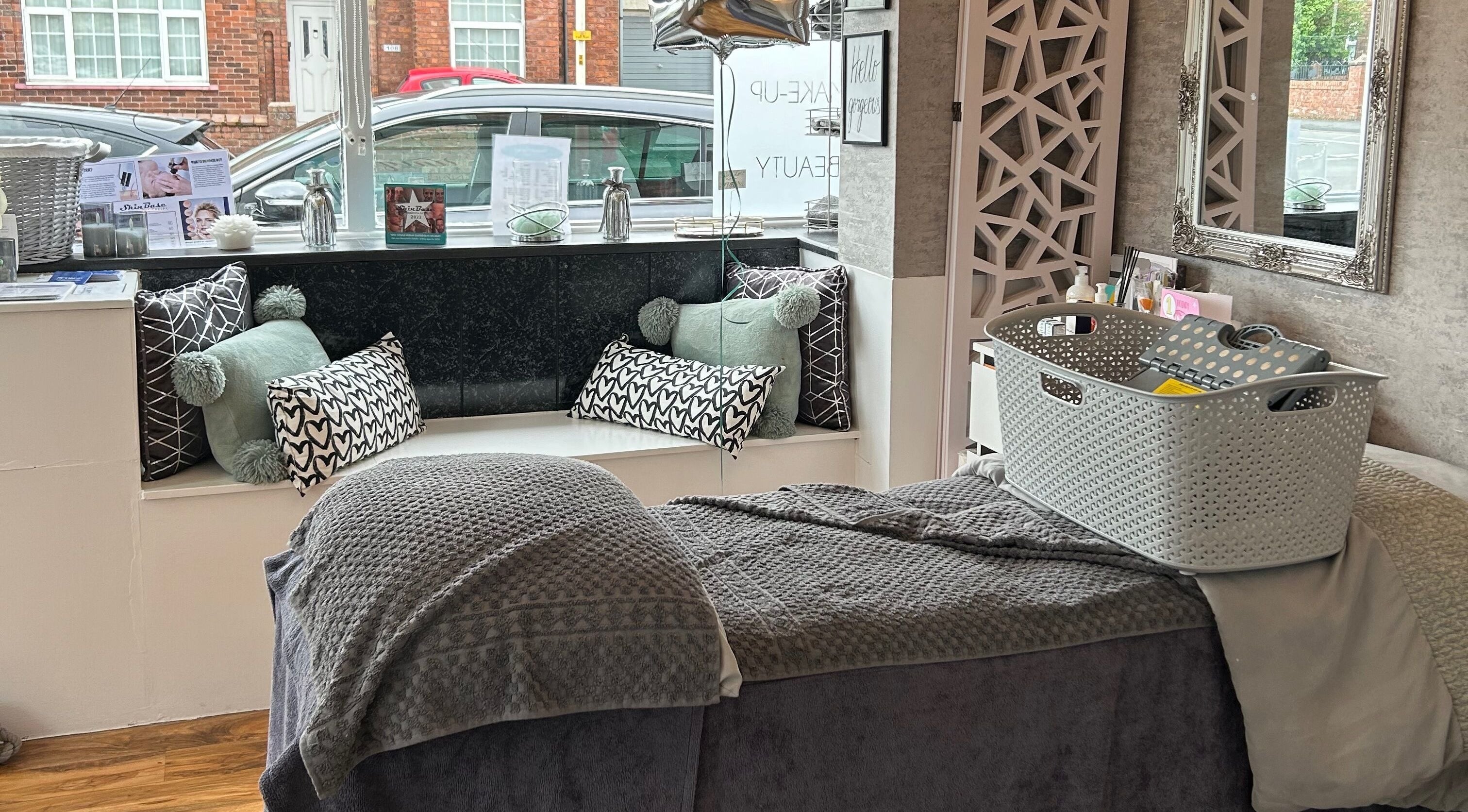 Cozy treatment area at Emma Jane Beauty Holistics, Southport, England, GB; plush bedding and cushions on display.