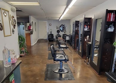 Modern interior of Hair Care Center in Burbank, California, US with sleek styling chairs and mirrors.