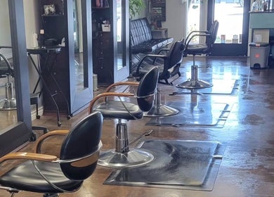 Stylish interior of Hair Care Center in Burbank, California, US with modern salon chairs and mirrors.