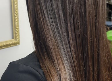 Shiny, straightened hair at Hair Care Center, Burbank, California, US, showcases expert hair treatment.