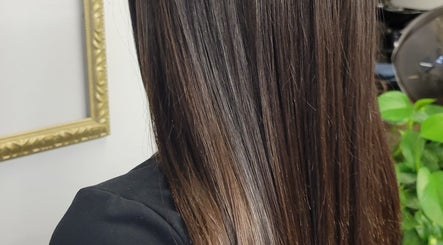 Shiny, straightened hair at Hair Care Center, Burbank, California, US, showcases expert hair treatment.