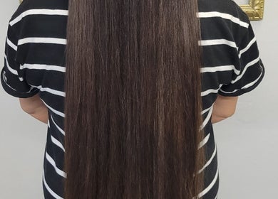 Long, silky brown hair at Hair Care Center in Burbank, California, US, showcasing expert hair treatments.