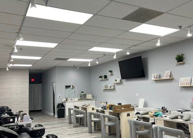 Modern interior of Y2 Nail Salon in Ontario, California, US featuring stylish nail stations and cozy seating.