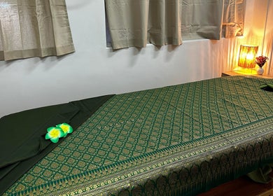 Massage table in calming room at Acacia Thai Massage, Melbourne, Victoria, AU, with soft lighting and decor.