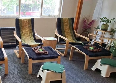 Relaxing lounge setup at Acacia Thai Massage, Melbourne, Victoria, AU with chairs and plants for ambiance.