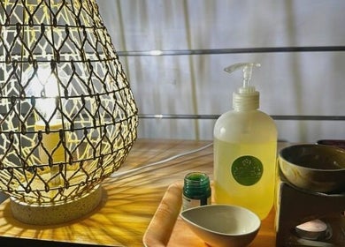 Relaxing spa setup at Acacia Thai Massage in Melbourne, Victoria, AU with a lit lamp and essential oils.