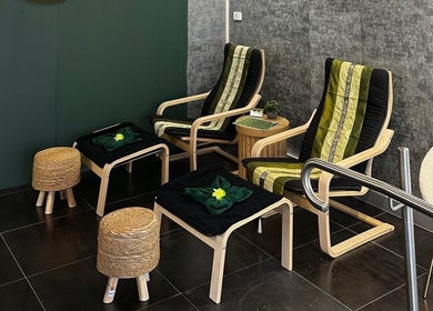 Cozy seating area at Elegant Thai Massage in Melbourne, Australia, AU, featuring comfortable wooden chairs and decor.