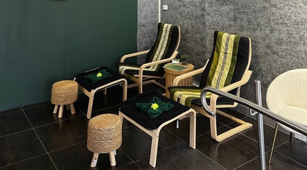 Cozy seating area at Elegant Thai Massage in Melbourne, Australia, AU, featuring comfortable wooden chairs and decor.