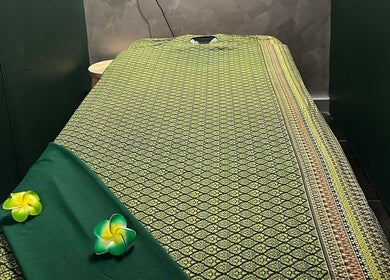 Serene massage bed at Elegant Thai Massage in Melbourne, Australia, AU, adorned with green patterns.