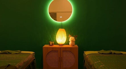 Peaceful massage room at Elegant Thai Massage, Hair Spa and Foot Spa, Melbourne, Victoria, AU with ambient green lighting.