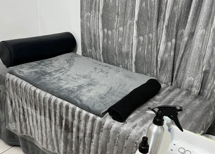 Cozy treatment room at Get It Bae Cpt, Cape Town, Western Cape, ZA with plush gray linens and serene ambiance.