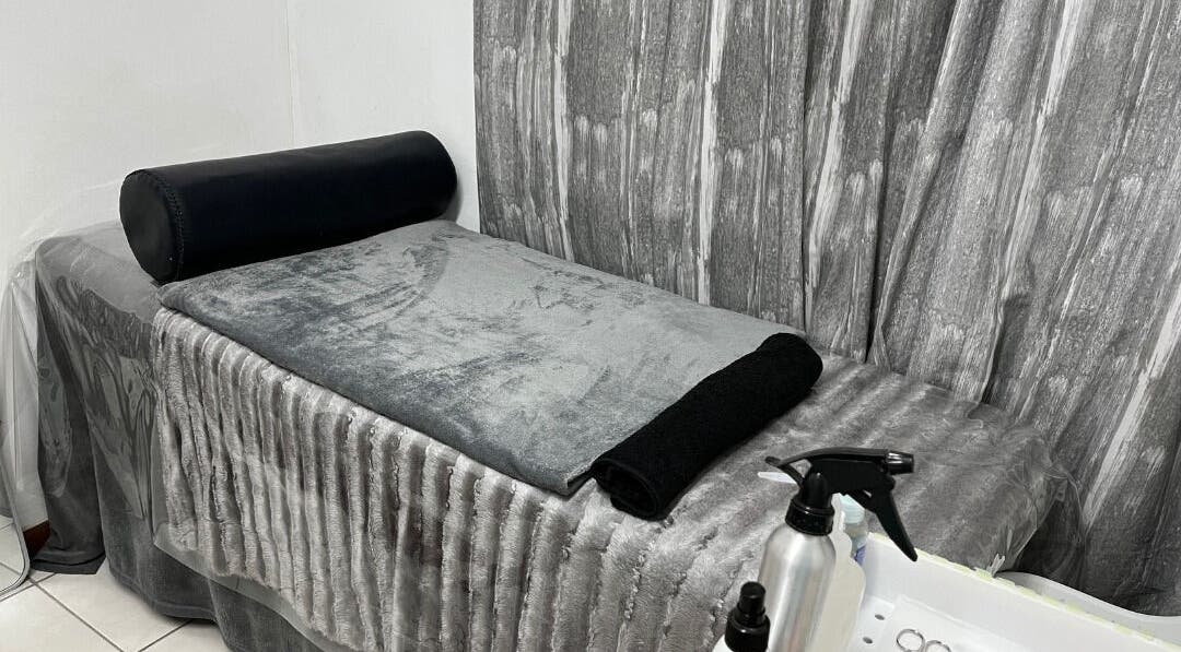 Cozy treatment room at Get It Bae Cpt, Cape Town, Western Cape, ZA with plush gray linens and serene ambiance.