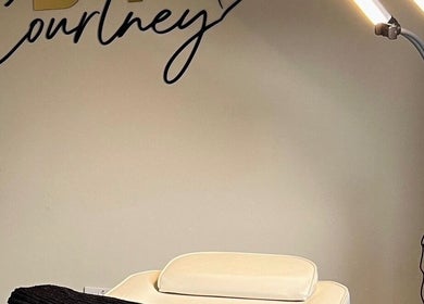 Elegant therapy station at ByCourtneyO in Huntington, England, GB with soft lighting and comfortable furnishings.