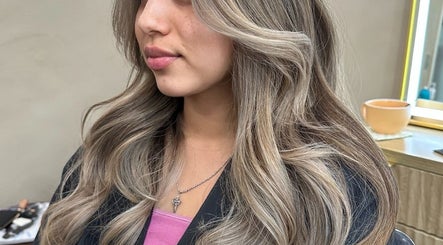 Stylish hair highlights at Elizabeth Marie Hair, Clarksville, Tennessee, US. Close-up of woman's wavy hairstyle.