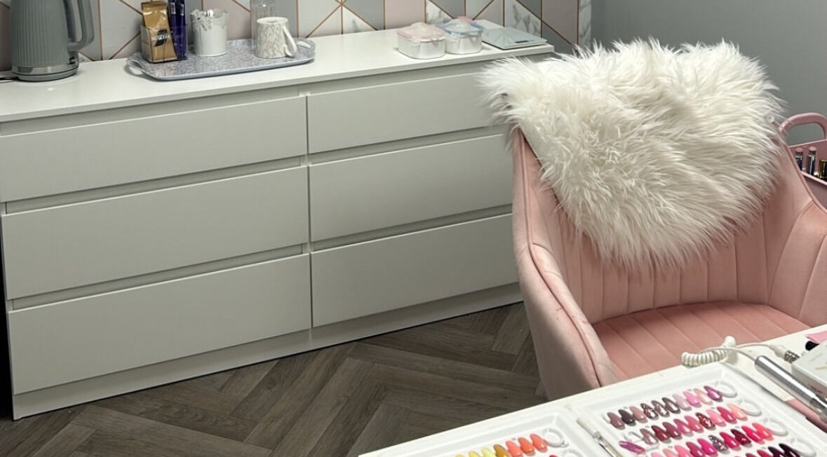 CLC Nails in Telford, England, GB features a chic nail station with soft pink chair and nail polish samples.