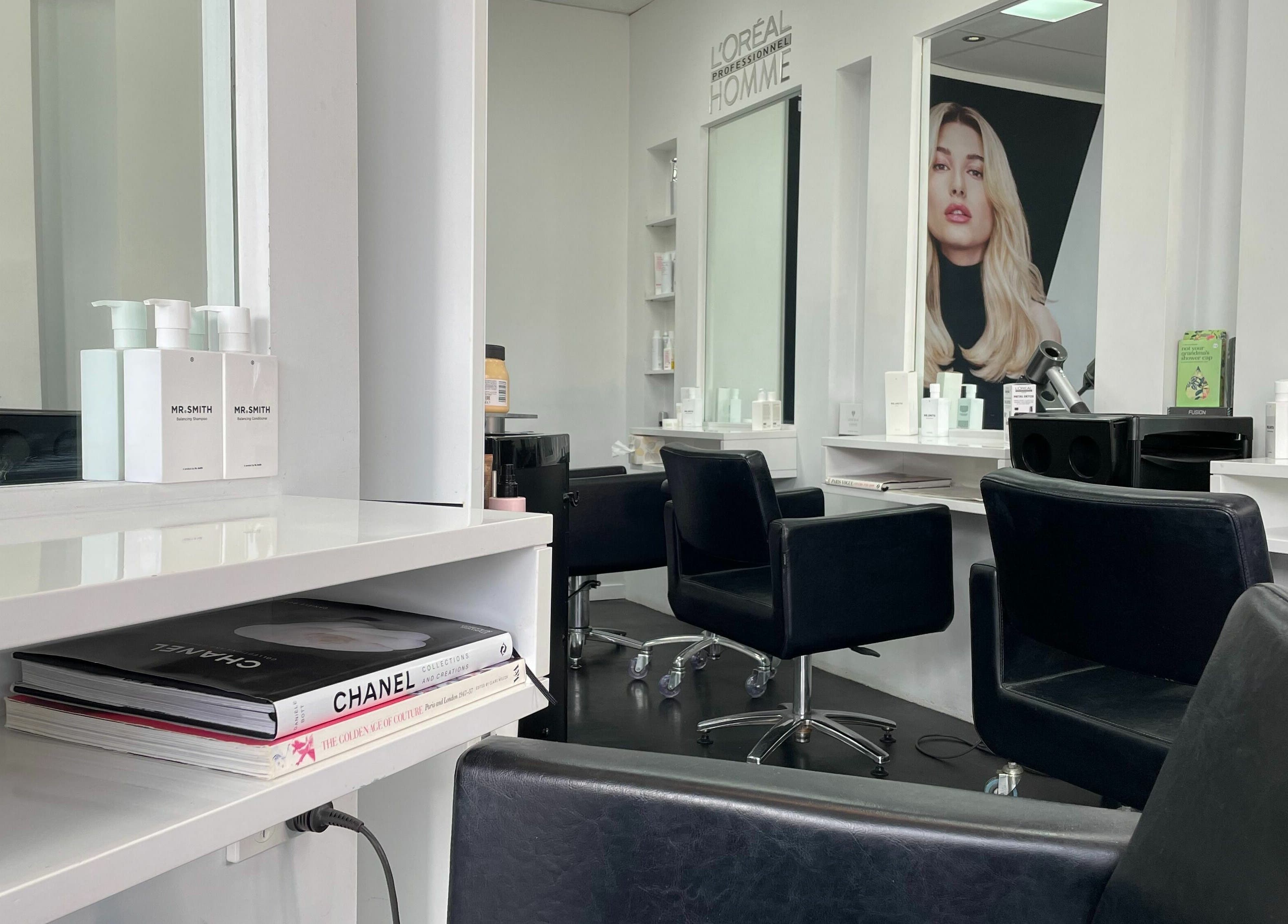 Modern salon interior at Suite Three, Buderim, Queensland, AU, featuring stylish black chairs and elegant decor.