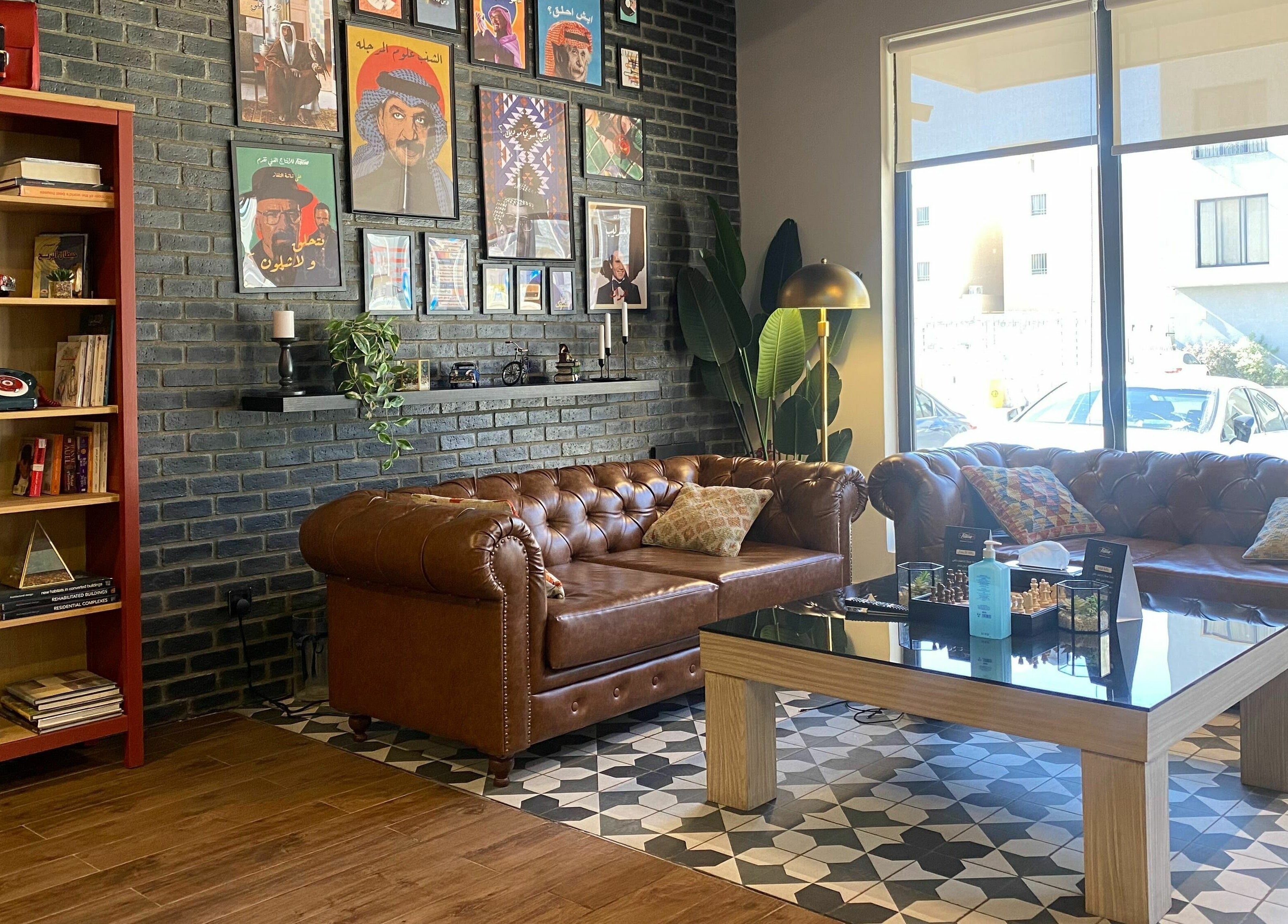 Cozy lounge at Fellow | حلاق فيلو, Riyadh, SA with leather sofas and artistic decor.