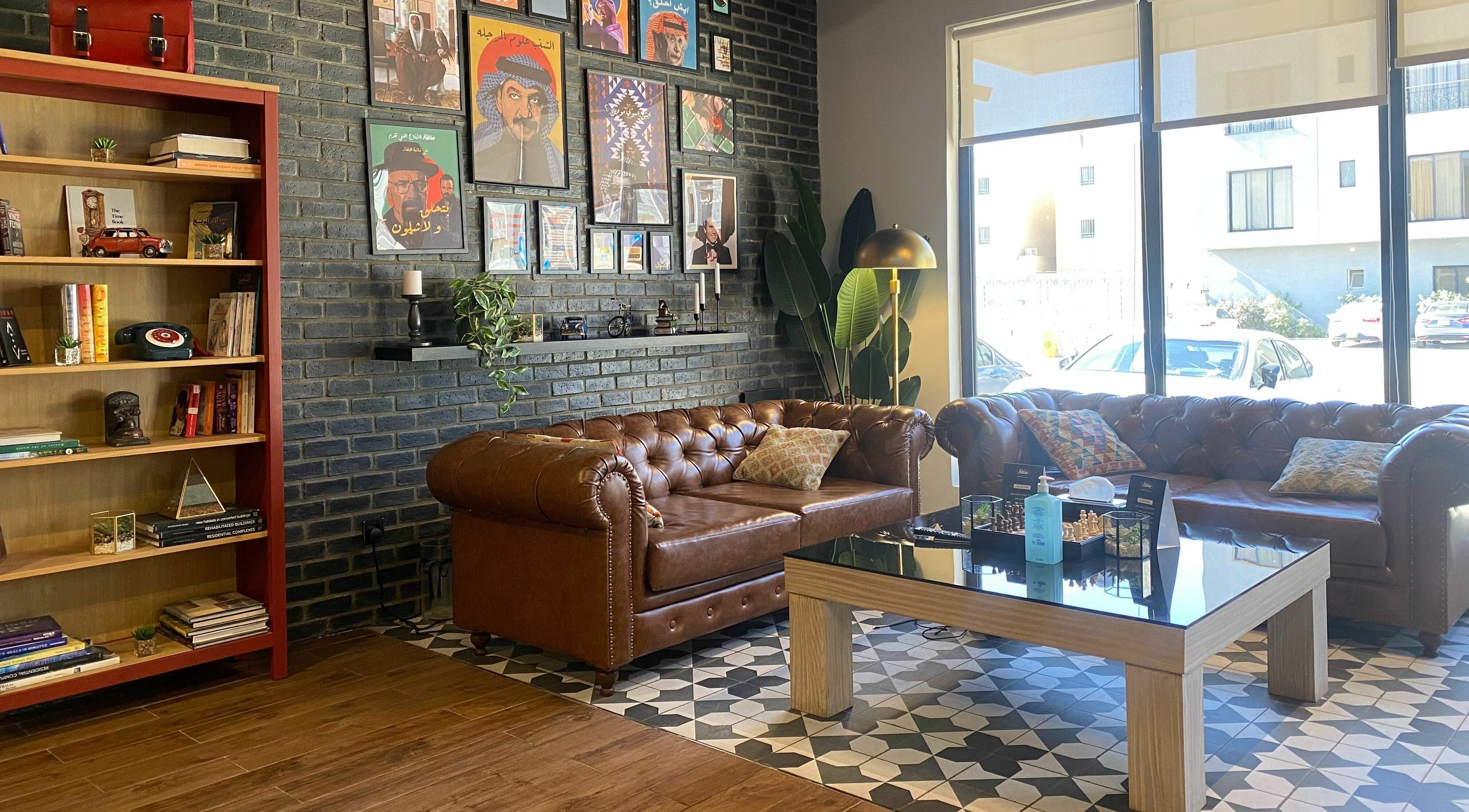 Cozy lounge at Fellow | حلاق فيلو, Riyadh, SA with leather sofas and artistic decor.