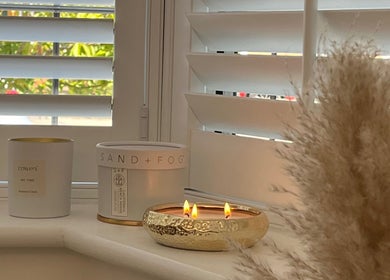 Lit candles on window sill at NailsByLily, Hinckley, England, GB, creating a serene and inviting atmosphere.