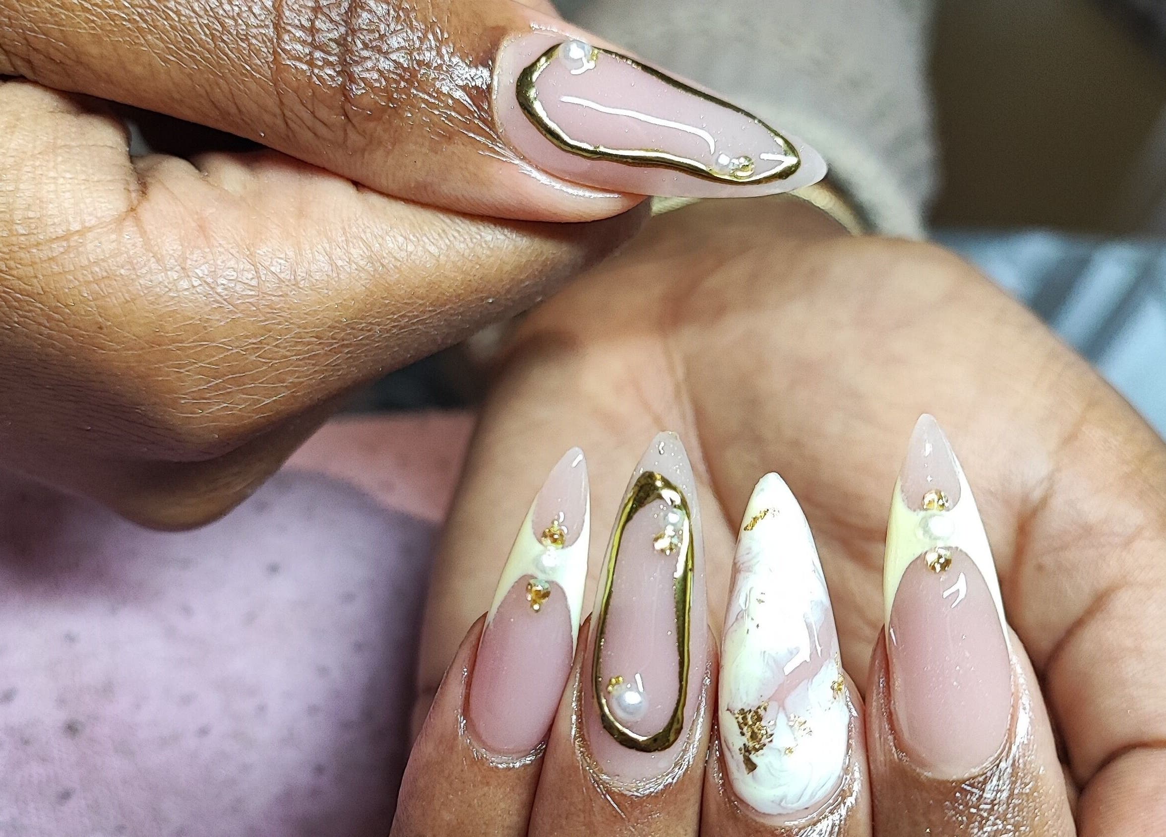 Stylish nail art at Micakayla's Nail Room, Ennerdale, Gauteng, ZA, showcasing elegant gold-trimmed designs.