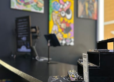 Interior of Bonaire Ink Tattoo and Piercing Shop in Kralendijk, Bonaire, BQ, showcasing art and jewelry display.