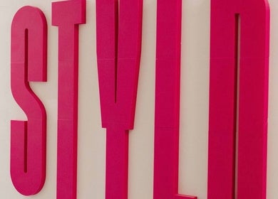 Bold pink STYLD sign at the entrance in Bath, England, GB