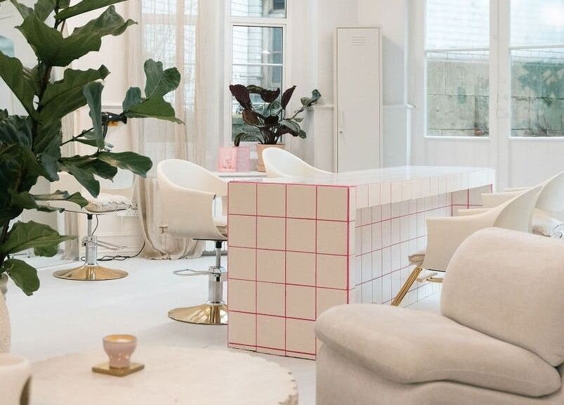 Modern salon interior at STYLD, Bath, England, GB with stylish furniture and lush plants.